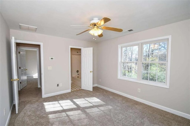 unfurnished bedroom featuring light colored carpet and ceiling fan