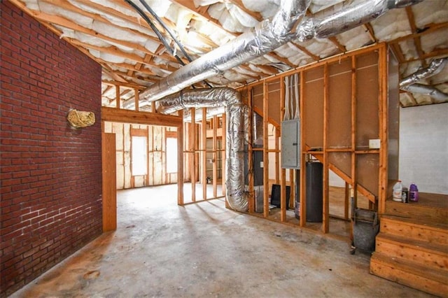 basement with electric panel and brick wall