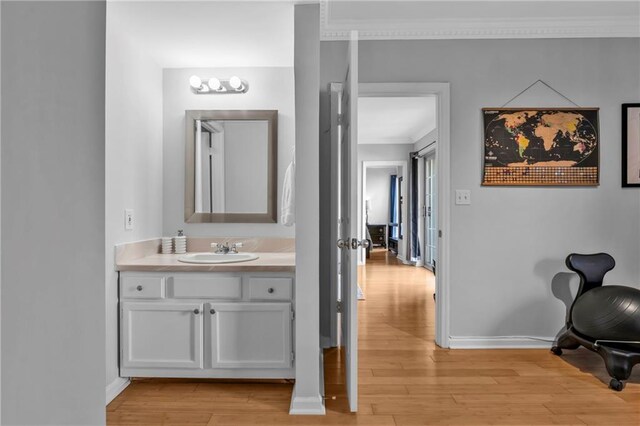 199 14th St NE Unit 2010, Atlanta, GA 30309 - bathroom featuring ornamental molding, wood finished floors, vanity, and baseboards