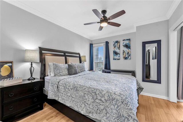 199 14th St NE Unit 2010, Atlanta, GA 30309 - bedroom featuring a ceiling fan, light wood-style flooring, baseboards, and crown molding
