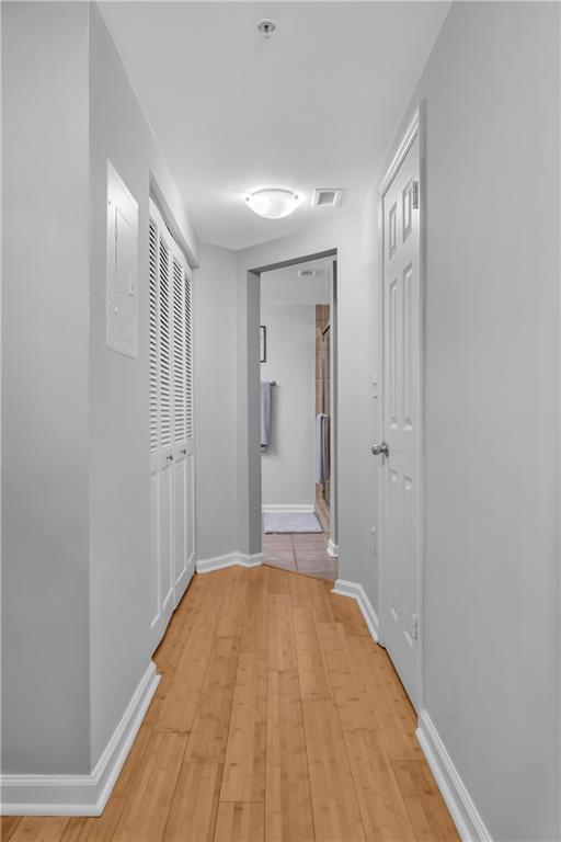 199 14th St NE Unit 2010, Atlanta, GA 30309 - corridor featuring light wood finished floors, visible vents, and baseboards
