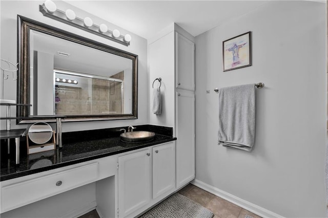 199 14th St NE Unit 2010, Atlanta, GA 30309 - bathroom with tile patterned flooring, a tile shower, vanity, and baseboards