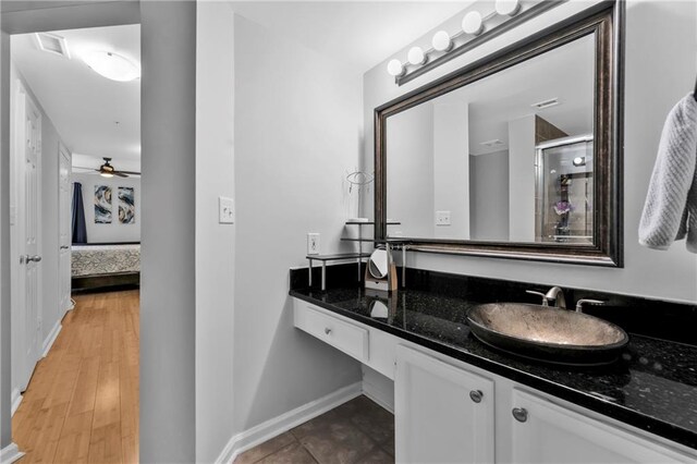 199 14th St NE Unit 2010, Atlanta, GA 30309 - bathroom with connected bathroom, visible vents, vanity, baseboards, and a stall shower