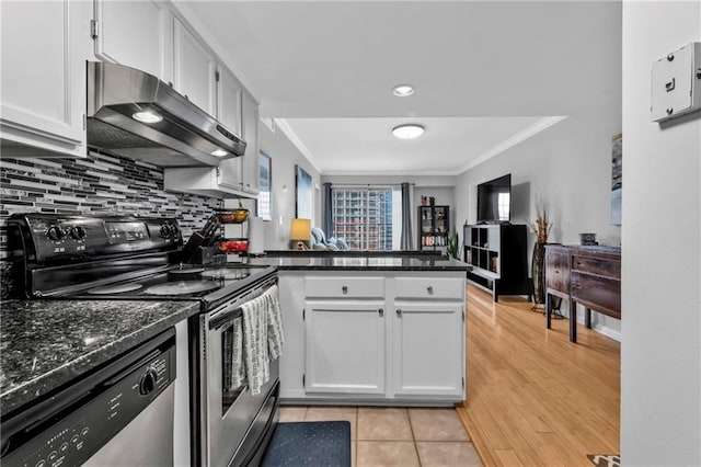 199 14th St NE Unit 2010, Atlanta, GA 30309 - kitchen with a peninsula, stainless steel appliances, ornamental molding, and ventilation hood