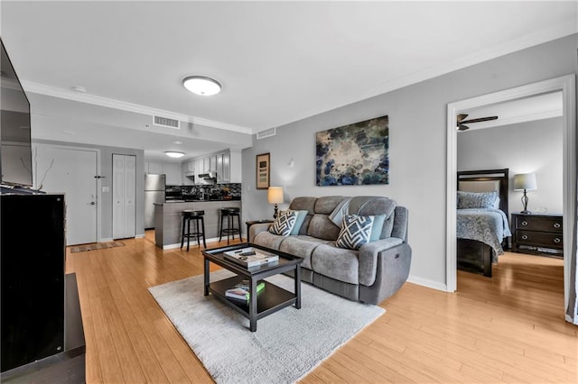 199 14th St NE Unit 2010, Atlanta, GA 30309 - living room featuring light wood-type flooring, baseboards, visible vents, and crown molding