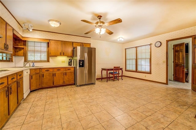 1850 Francis Rd SW, Conyers, GA 30094 - kitchen with stainless steel refrigerator with ice dispenser, white dishwasher, brown cabinets, light countertops, and wallpapered walls