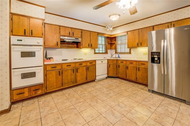 1850 Francis Rd SW, Conyers, GA 30094 - kitchen featuring white appliances, brown cabinets, wallpapered walls, and under cabinet range hood
