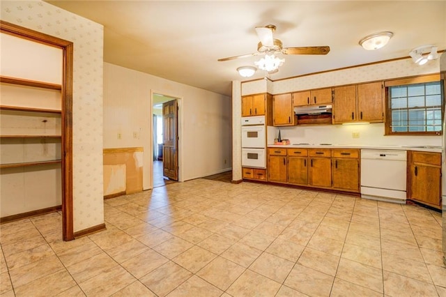 1850 Francis Rd SW, Conyers, GA 30094 - kitchen featuring white appliances, wallpapered walls, brown cabinetry, and light countertops