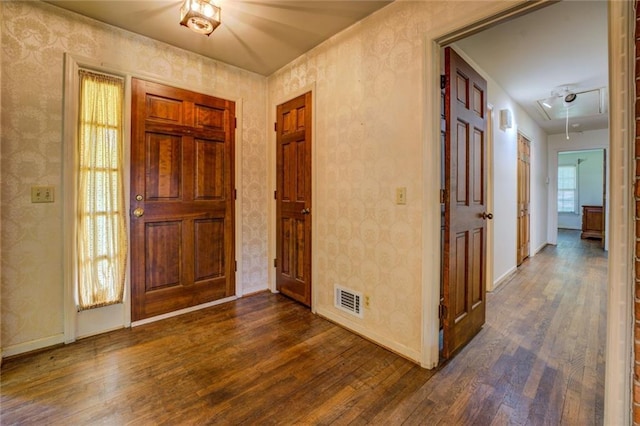 1850 Francis Rd SW, Conyers, GA 30094 - entryway with baseboards, wallpapered walls, dark wood-style flooring, and visible vents