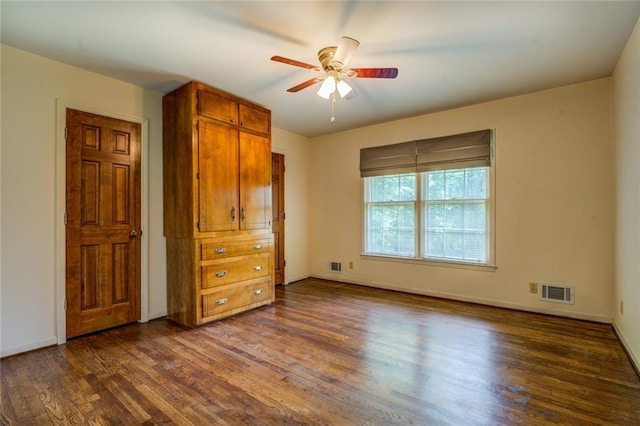 1850 Francis Rd SW, Conyers, GA 30094 - unfurnished bedroom featuring a ceiling fan, baseboards, visible vents, and dark wood-style floors