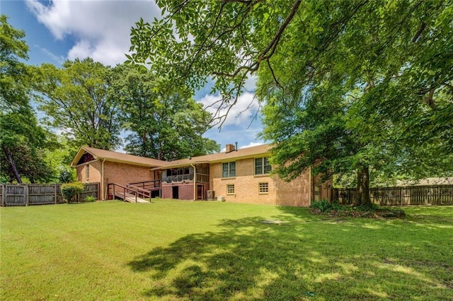 1850 Francis Rd SW, Conyers, GA 30094 - rear view of property featuring a fenced backyard, a yard, and brick siding