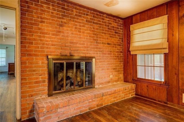 1850 Francis Rd SW, Conyers, GA 30094 - unfurnished living room with a brick fireplace, wooden walls, and hardwood / wood-style flooring