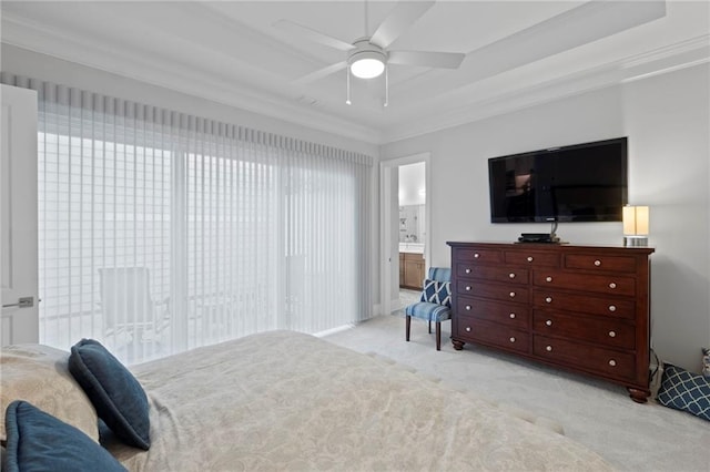 bedroom featuring light carpet, ornamental molding, a raised ceiling, ensuite bathroom, and ceiling fan