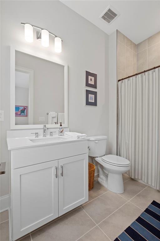 bathroom featuring vanity, toilet, tile patterned floors, and a shower with shower curtain