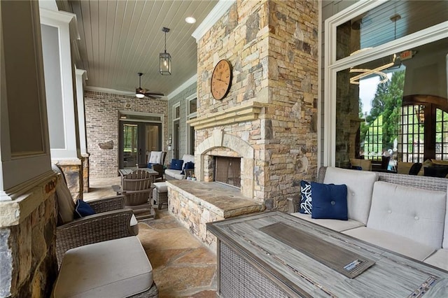 view of patio / terrace featuring an outdoor living space with a fireplace and ceiling fan