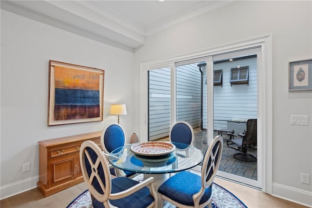 dining room featuring light hardwood / wood-style floors and ornamental molding