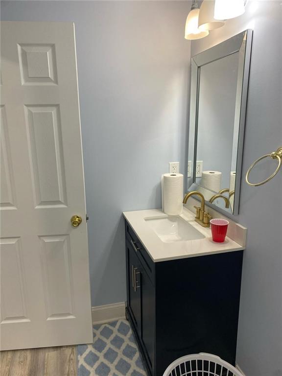 4520 Essen Ln, Cumming, GA 30041 - bathroom with vanity and baseboards
