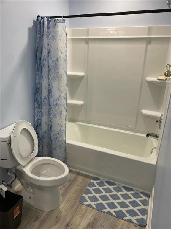 4520 Essen Ln, Cumming, GA 30041 - bathroom with wood finished floors, toilet, and shower / bath combo