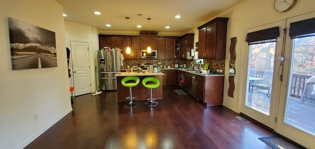 4520 Essen Ln, Cumming, GA 30041 - kitchen featuring appliances with stainless steel finishes, plenty of natural light, a kitchen island, dark wood-style flooring, and recessed lighting