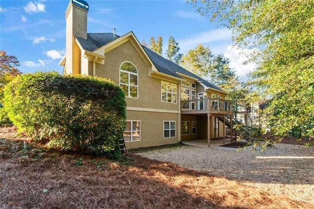 back of property with a patio and a deck