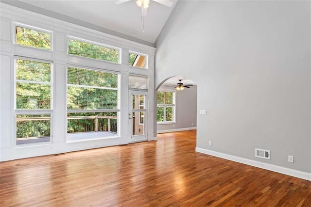 unfurnished living room with ceiling fan, light hardwood / wood-style floors, and high vaulted ceiling