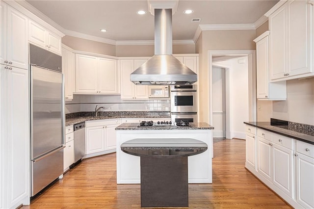 kitchen featuring light hardwood / wood-style flooring, white cabinets, and stainless steel appliances