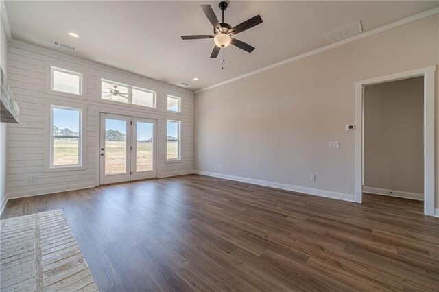 unfurnished living room with visible vents, a brick fireplace, wood finished floors, and crown molding