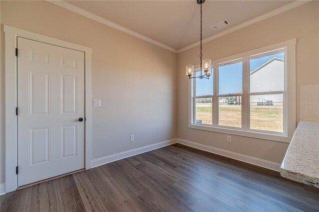 unfurnished dining area featuring baseboards, visible vents, dark wood finished floors, ornamental molding, and a chandelier