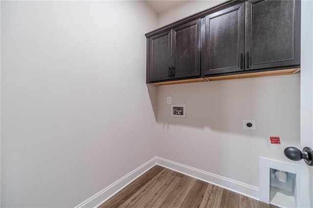 laundry room with wood finished floors, cabinet space, baseboards, hookup for an electric dryer, and hookup for a washing machine