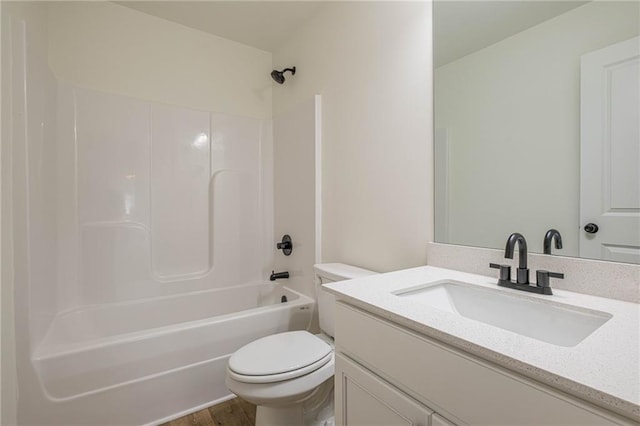 bathroom featuring vanity, toilet, wood finished floors, and bathing tub / shower combination