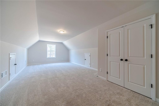 bonus room with lofted ceiling, carpet, visible vents, and baseboards