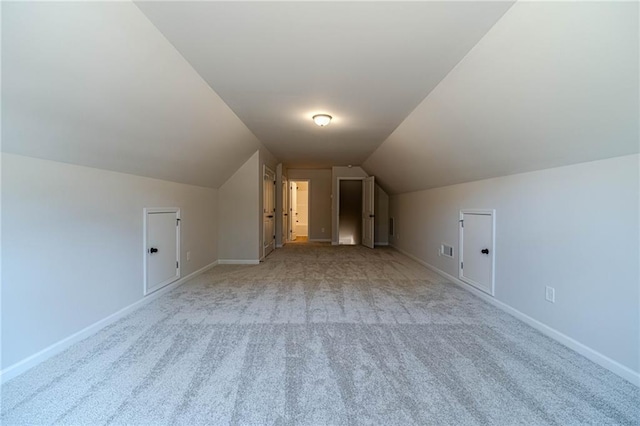 additional living space with lofted ceiling, carpet flooring, and baseboards