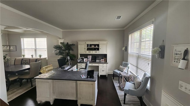 office area featuring ornamental molding, dark wood-style floors, arched walkways, and visible vents