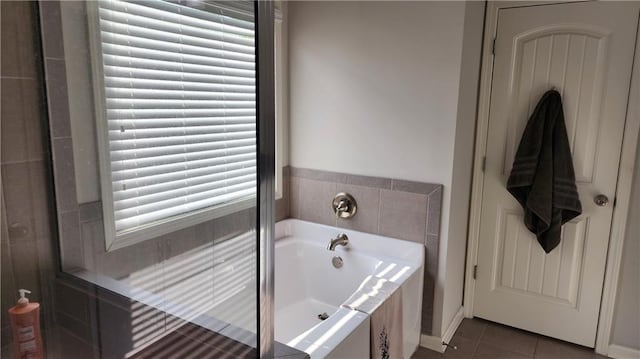 full bath featuring tile patterned flooring and a bath