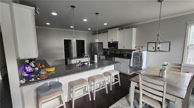kitchen featuring ornamental molding, a sink, and stainless steel appliances