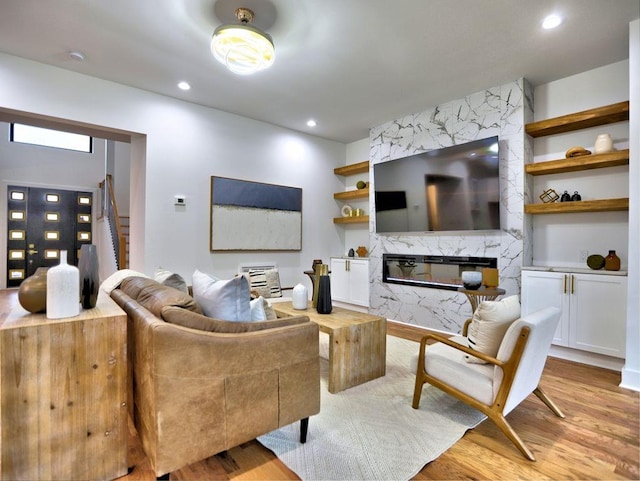 living room with a fireplace and light hardwood / wood-style flooring