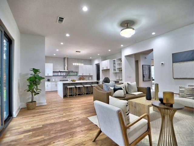 living room featuring a healthy amount of sunlight and light hardwood / wood-style floors