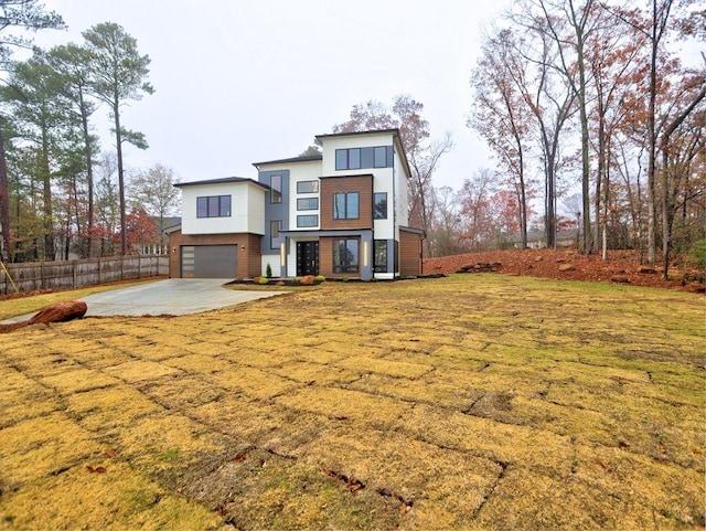 modern home featuring a garage and a front lawn