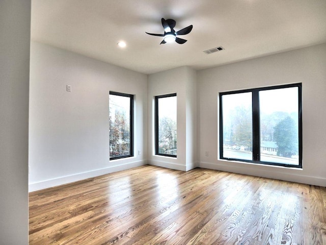 spare room featuring ceiling fan and hardwood / wood-style flooring