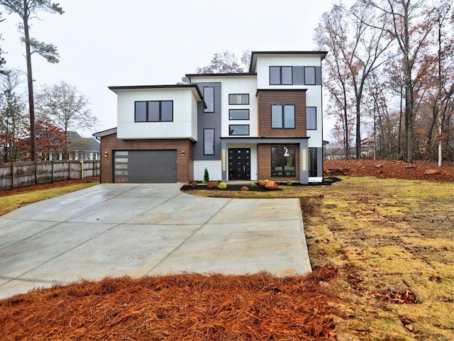 modern home featuring a garage and a front lawn