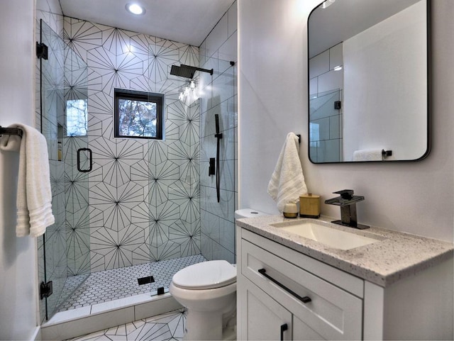 bathroom featuring walk in shower, tile patterned floors, vanity, and toilet