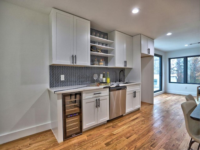 kitchen featuring dishwasher, light wood-type flooring, white cabinets, and beverage cooler