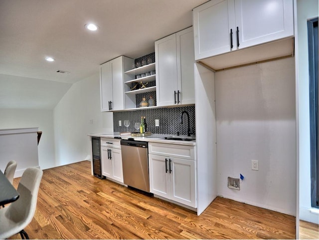 kitchen with dishwasher, white cabinetry, decorative backsplash, and light wood-type flooring