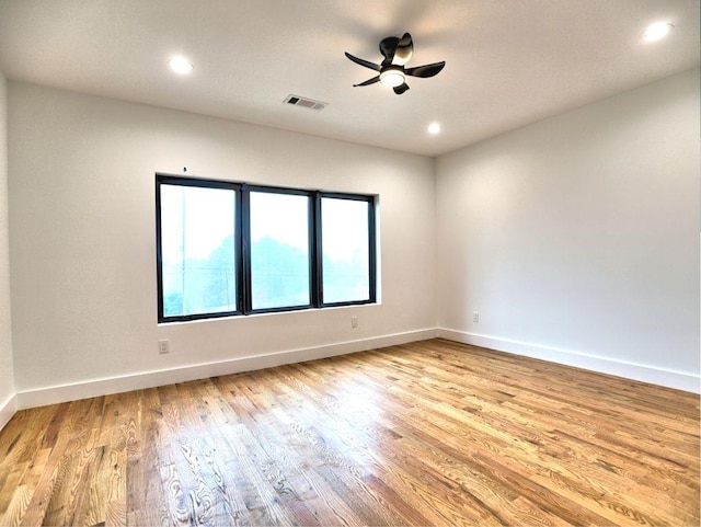 spare room featuring ceiling fan and light wood-type flooring