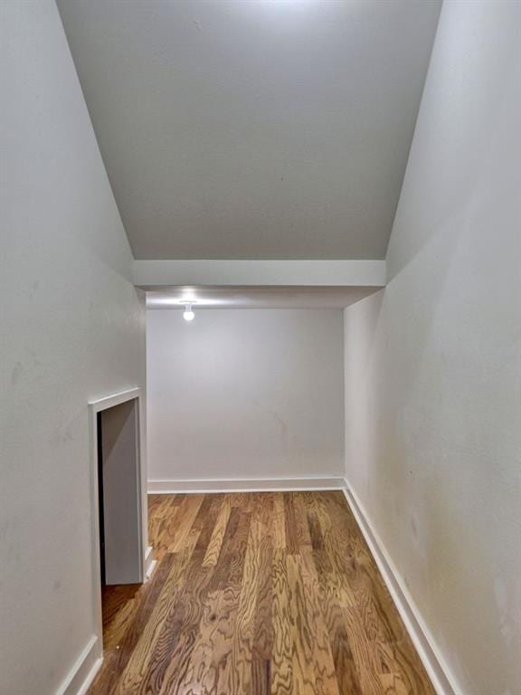 interior space featuring dark hardwood / wood-style floors and vaulted ceiling