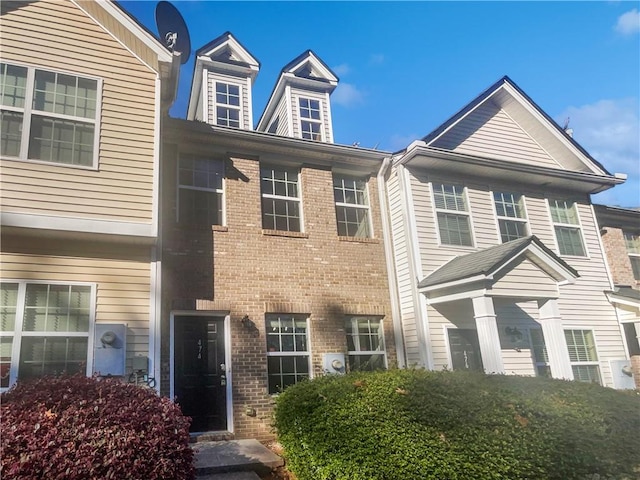 view of property featuring brick siding