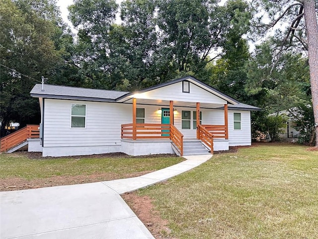 view of front of home with covered porch and a front yard