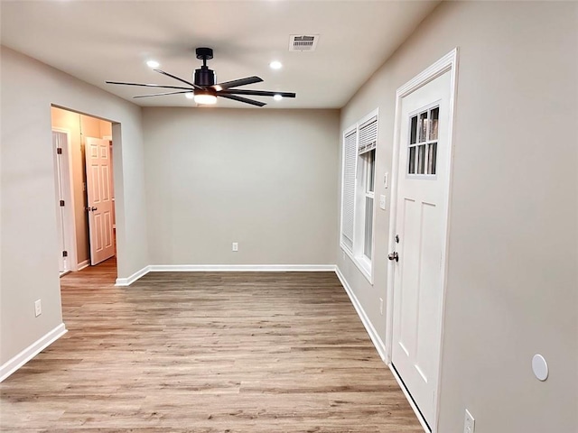 unfurnished room with light wood-type flooring and ceiling fan