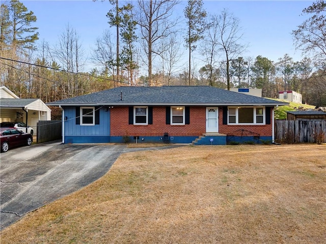 single story home with driveway, brick siding, a shingled roof, fence, and a front yard