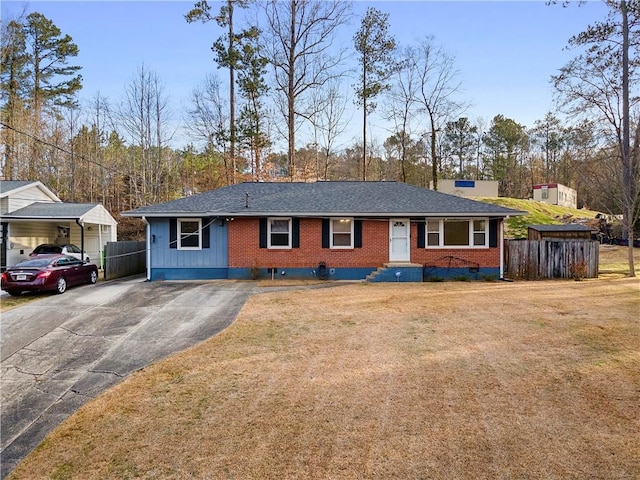 single story home featuring driveway, a shingled roof, fence, a front yard, and brick siding